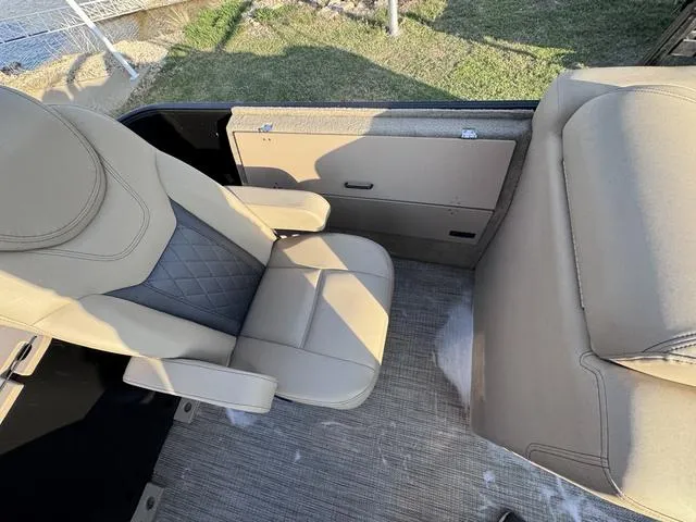 Slide: The Image of 2023 Starcraft CX23FD boat interior with beige seating and carpeted flooring. - 12