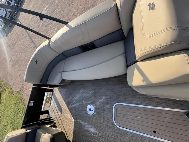 Slide: The Image of 2023 Starcraft CX23FD boat interior with beige seating and deck flooring. - 18