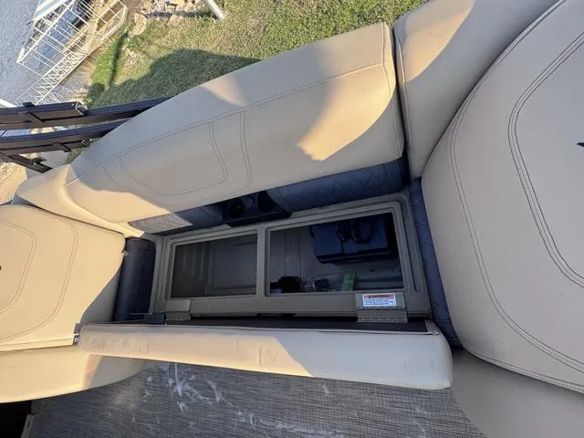 Slide: The Image of 2023 Starcraft CX23FD boat interior with beige seating and storage compartment. - 21