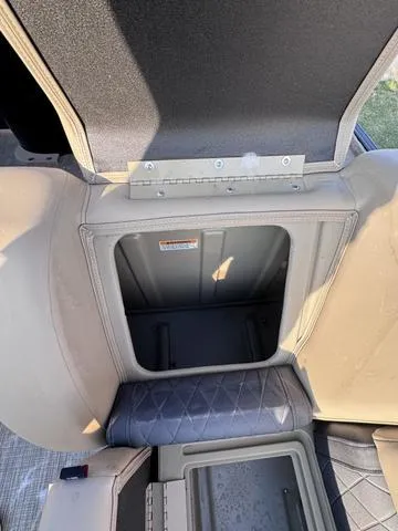 Slide: The Image of 2023 Starcraft CX23FD storage compartment with open lid, showcasing interior space. - 22