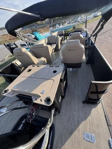 Slide: The Image of 2023 Starcraft CX23FD pontoon boat interior with seating and table. - 6