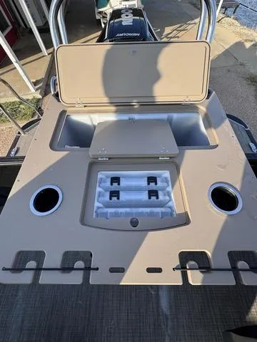 Slide: The Image of 2023 Starcraft CX23FD boat console with storage compartments and cup holders. - 8