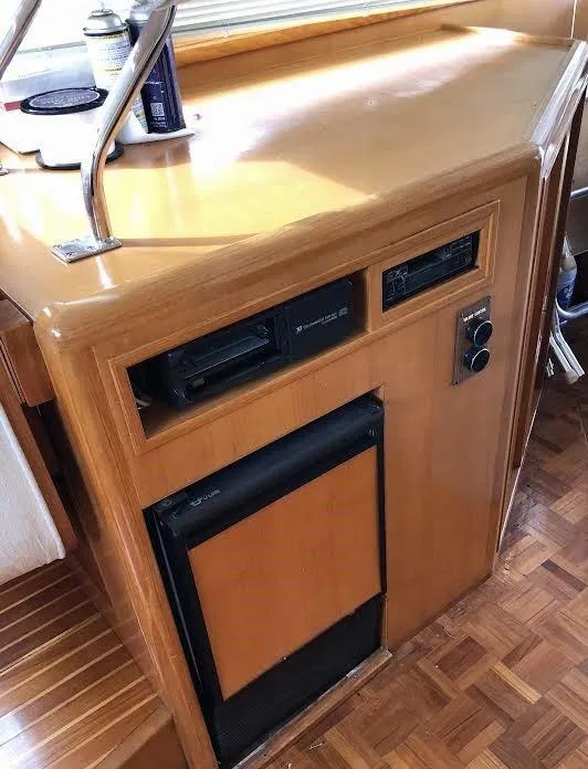 Slide: The Image of 1999 Ocean Alexander Classico 450 yacht interior with wooden cabinetry and built-in appliances. - 15