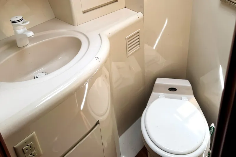 Slide: The Image of Bathroom interior of 1999 Ocean Alexander Classico 450 yacht, featuring sink and toilet. - 20