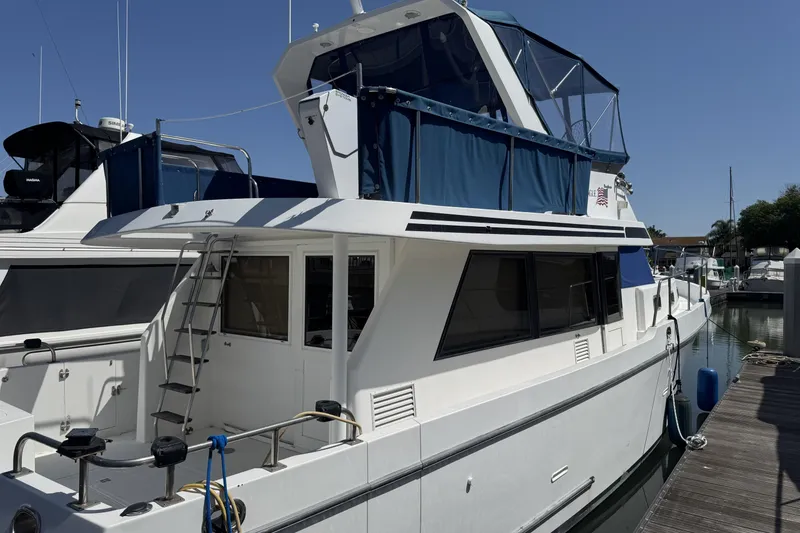 Slide: The Image of Ocean Alexander Classico 450 yacht, 1999 model, docked at marina under clear blue sky. - 3