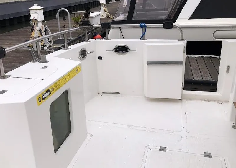 Slide: The Image of 1999 Ocean Alexander Classico 450 yacht deck with open hatch and railing. - 4