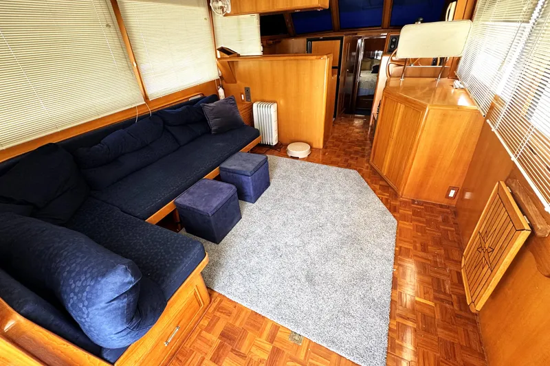 Slide: The Image of Luxurious 1999 Ocean Alexander Classico 450 yacht interior with cozy seating and elegant wood finishes. - 7