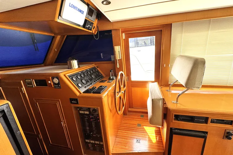 Slide: The Image of Interior helm of 1999 Ocean Alexander Classico 450 yacht with wooden finish and navigation equipment. - 8