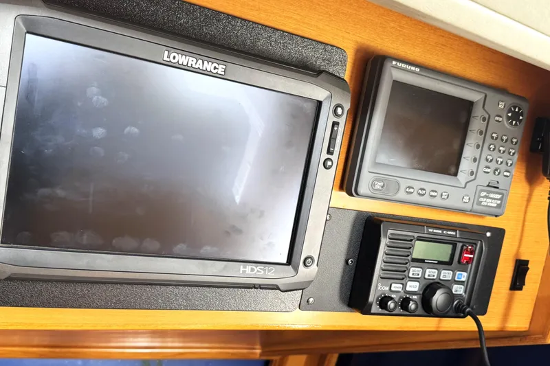 Slide: The Image of Navigation equipment on a 1999 Ocean Alexander Classico 450 yacht dashboard. - 9