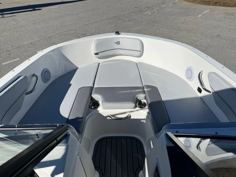 Slide: The Image of 2024 Bayliner VR4 boat interior with cushioned seating and cup holders. - 17
