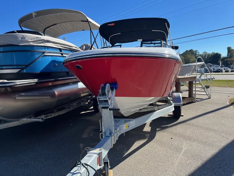 Slide: The Image of 2024 Bayliner VR4 boat on a trailer, red hull, parked outdoors. - 3