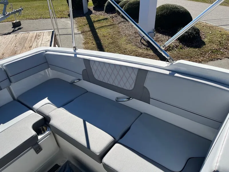 Slide: The Image of 2024 Bayliner VR4 boat interior with cushioned seating and sleek design. - 5