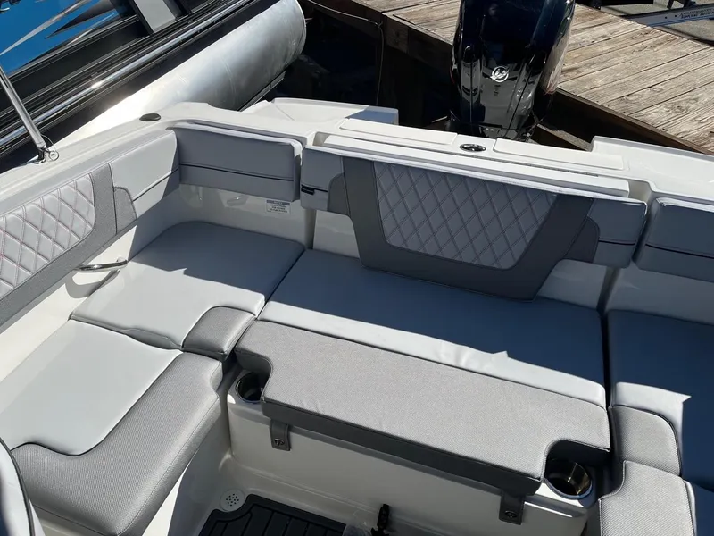 Slide: The Image of 2024 Bayliner VR4 boat interior with cushioned seating and modern design. - 6