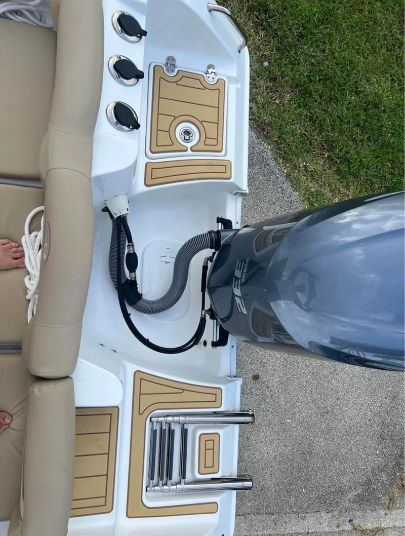Slide: The Image of 2018 Sea Hunt 235 boat stern with outboard motor and seating. - 12
