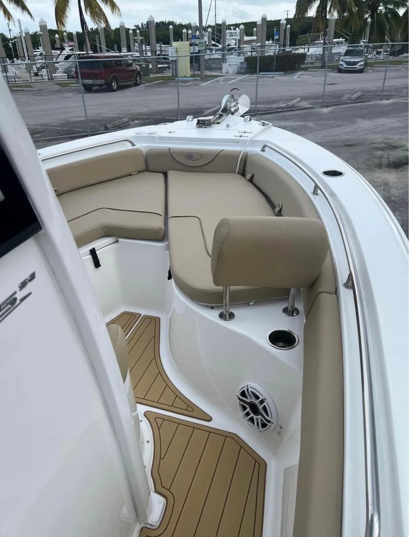 Slide: The Image of 2018 Sea Hunt 235 boat with cushioned seating and teak flooring. - 13