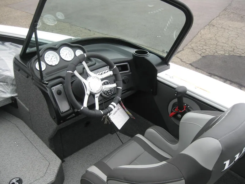 Slide: The Image of 2024 Lund 1775 Crossover XS boat interior with seating and dashboard. - 11