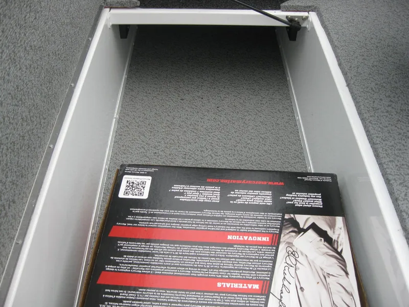 Slide: The Image of 2024 Lund 1775 Crossover XS storage compartment with open drawer. - 14