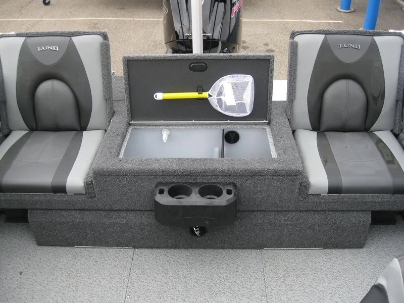 Slide: The Image of 2024 Lund 1775 Crossover XS boat interior with storage compartments and motor. - 9