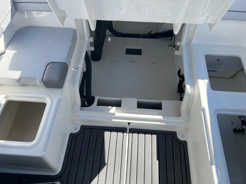 Slide: The Image of 2024 Bayliner VR4 boat interior storage compartments and seating area. - 10