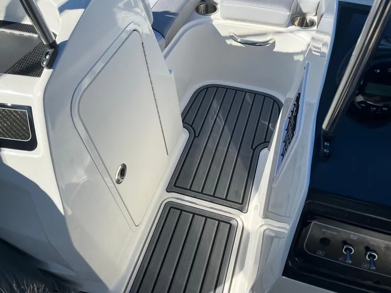 Slide: The Image of 2024 Bayliner VR4 boat interior with non-slip flooring and storage compartment. - 12