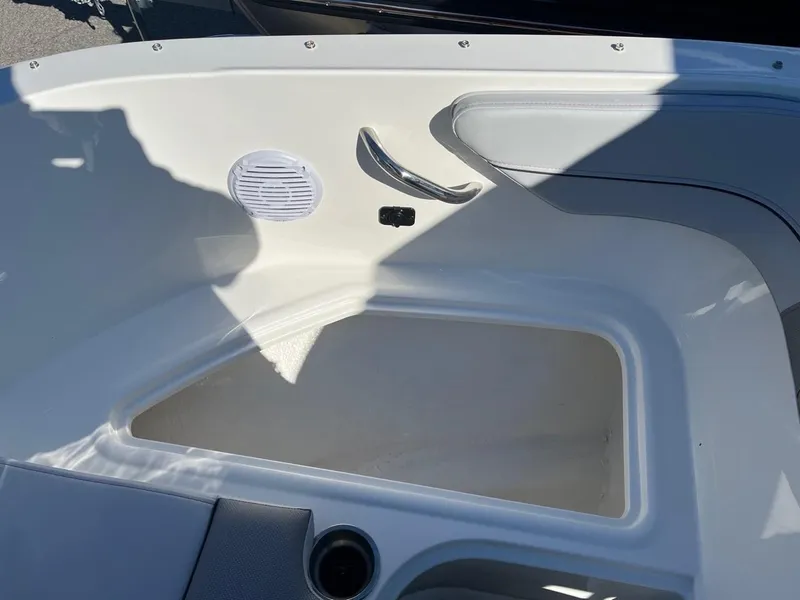 Slide: The Image of 2024 Bayliner VR4 boat interior storage compartment with speaker and cup holder. - 19