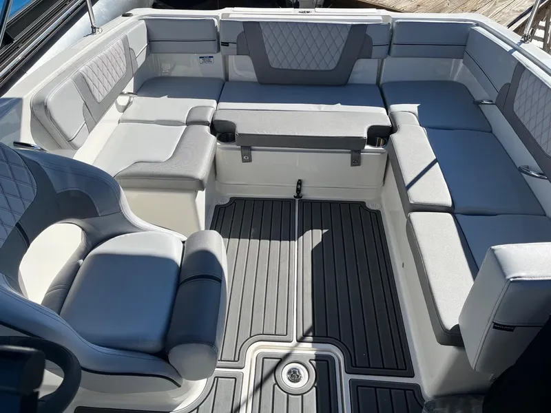 Slide: The Image of 2024 Bayliner VR4 boat interior with gray and white seating. - 7