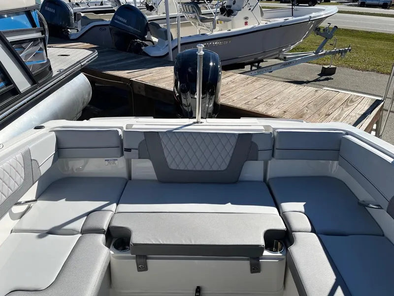Slide: The Image of 2024 Bayliner VR4 boat interior with cushioned seating and cup holders. - 9