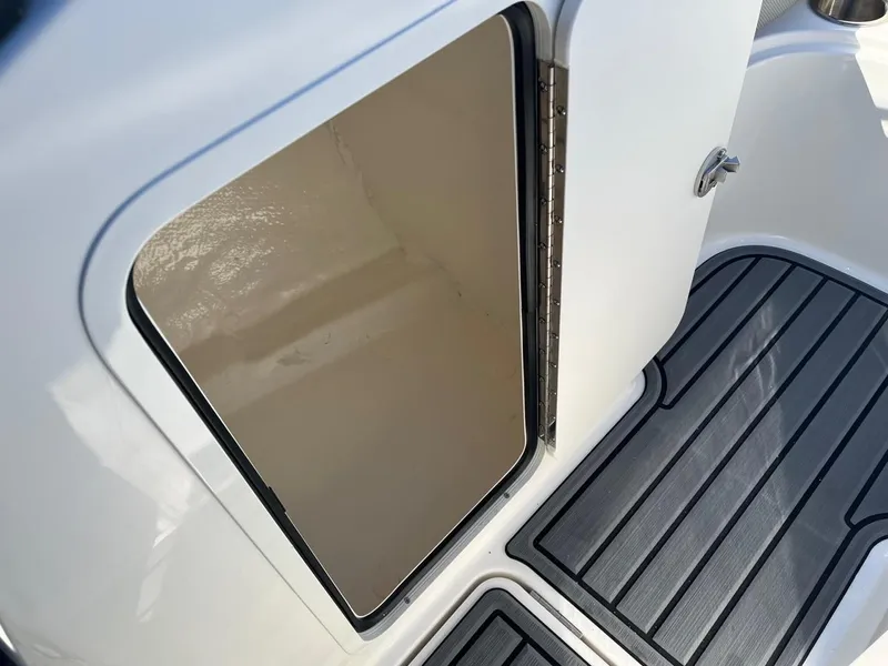 Slide: The Image of Open storage compartment on 2024 Bayliner VR4 boat with non-slip flooring. - 13