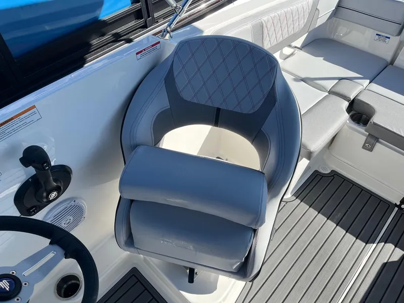 Slide: The Image of 2024 Bayliner VR4 boat interior with captain's chair and seating area. - 15