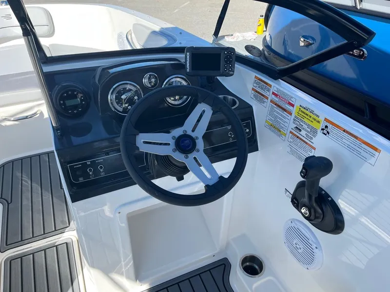 Slide: The Image of 2024 Bayliner VR4 boat cockpit with steering wheel and control panel. - 16