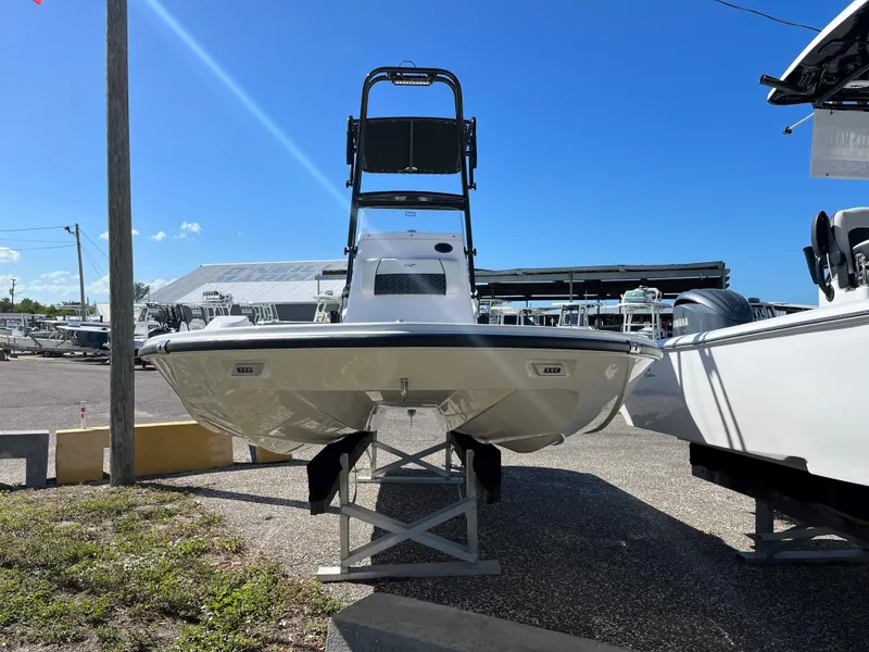 Slide: The Image of 2025 Tidewater 25 TPC boat on display in a marina under a clear blue sky. - 1