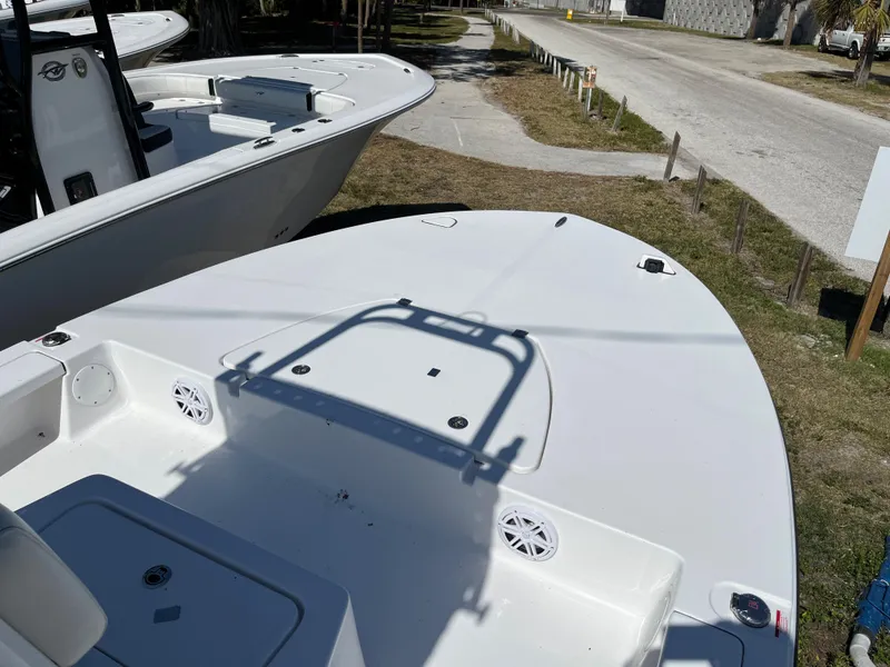 Slide: The Image of 2025 Tidewater 25 TPC boat, white deck, docked on land, sunny day. - 12