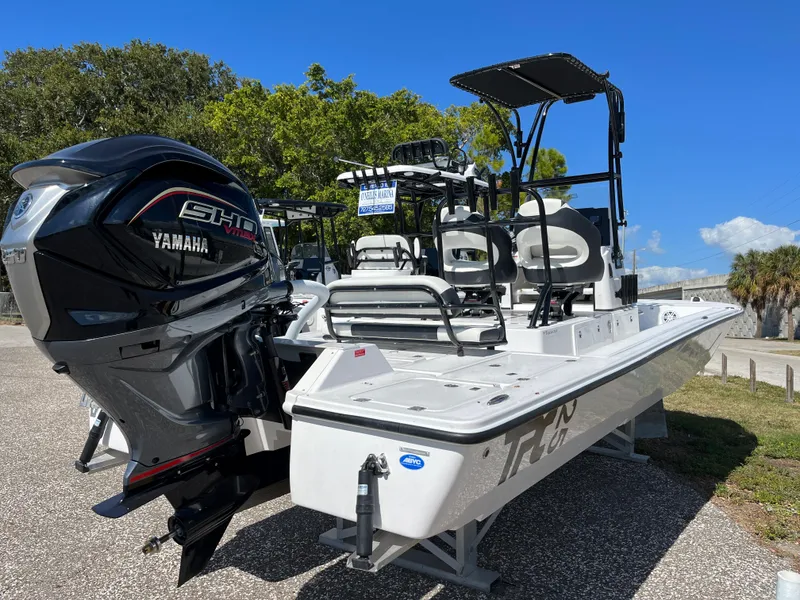 Slide: The Image of 2025 Tidewater 25 TPC boat with Yamaha engine, parked outdoors. - 2