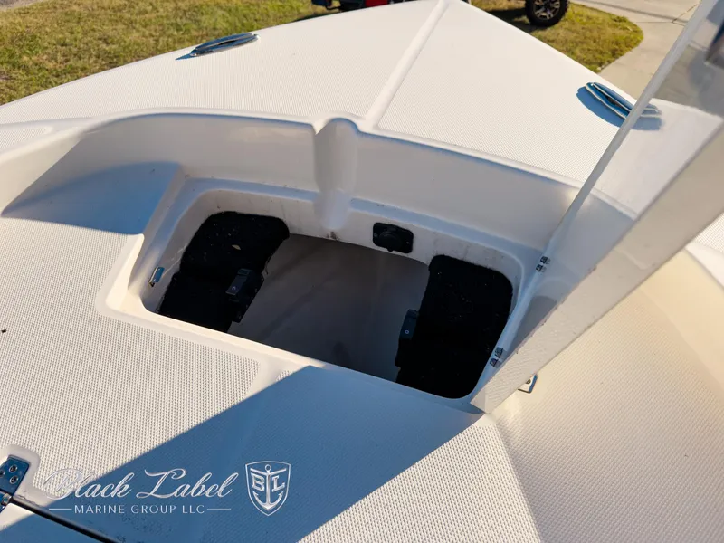 Slide: The Image of 2024 Pathfinder TRS 2200 boat storage compartment, open lid, sunny day. - 10