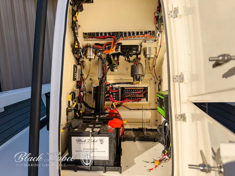 Slide: The Image of Interior view of 2024 Pathfinder TRS 2200 boat's electrical system and battery compartment. - 12