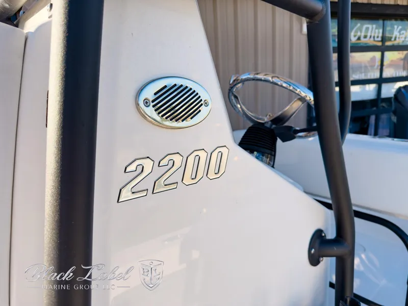 Slide: The Image of 2024 Pathfinder TRS 2200 boat detail with steering wheel and model number. - 14