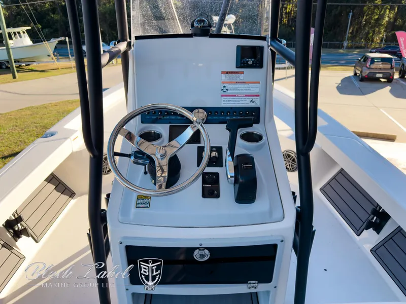 Slide: The Image of 2024 Pathfinder TRS 2200 boat console with steering wheel and controls. - 16