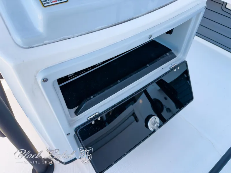 Slide: The Image of 2024 Pathfinder TRS 2200 boat storage compartment with open hatch, featuring sleek design. - 18