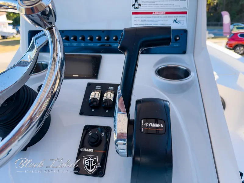 Slide: The Image of Control panel of 2024 Pathfinder TRS 2200 boat with Yamaha throttle and steering wheel. - 21