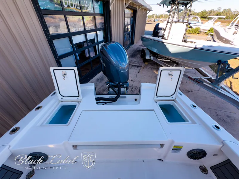 Slide: The Image of 2024 Pathfinder TRS 2200 boat with outboard motor, docked at marina. - 24