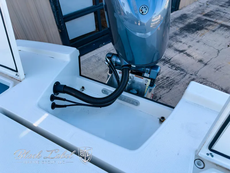 Slide: The Image of 2024 Pathfinder TRS 2200 boat engine area with cables and motor. - 25