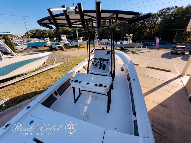 Slide: The Image of 2024 Pathfinder TRS 2200 boat with T-top, docked at marina under clear sky. - 26