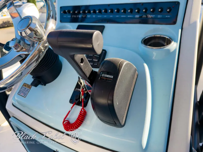 Slide: The Image of Close-up of 2024 Pathfinder TRS 2200 boat controls with Yamaha throttle. - 27