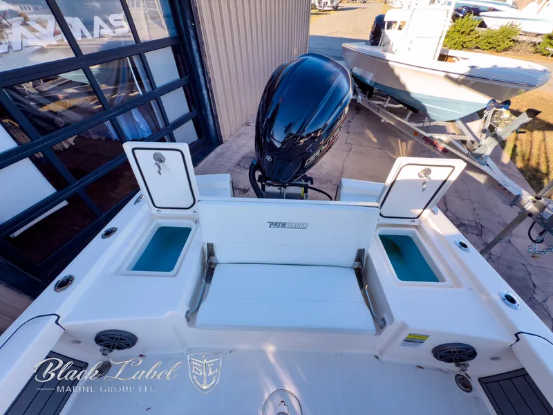 Slide: The Image of 2024 Pathfinder TRS 2200 boat with open storage compartments and outboard motor. - 30