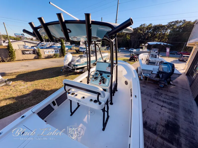 Slide: The Image of 2024 Pathfinder TRS 2200 boat with center console and T-top in a dealership lot. - 31