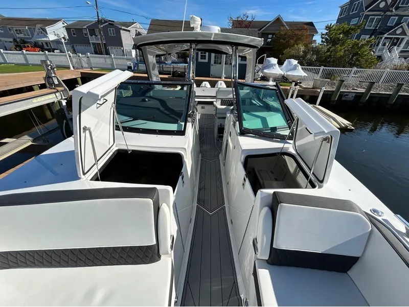 Slide: The Image of 2019 Monterey 385 SE boat docked at a marina, featuring spacious seating and modern design. - 17