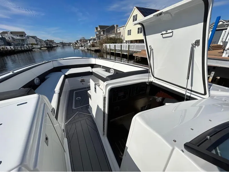 Slide: The Image of 2019 Monterey 385 SE boat docked in a residential canal, open hatch, sunny day. - 19