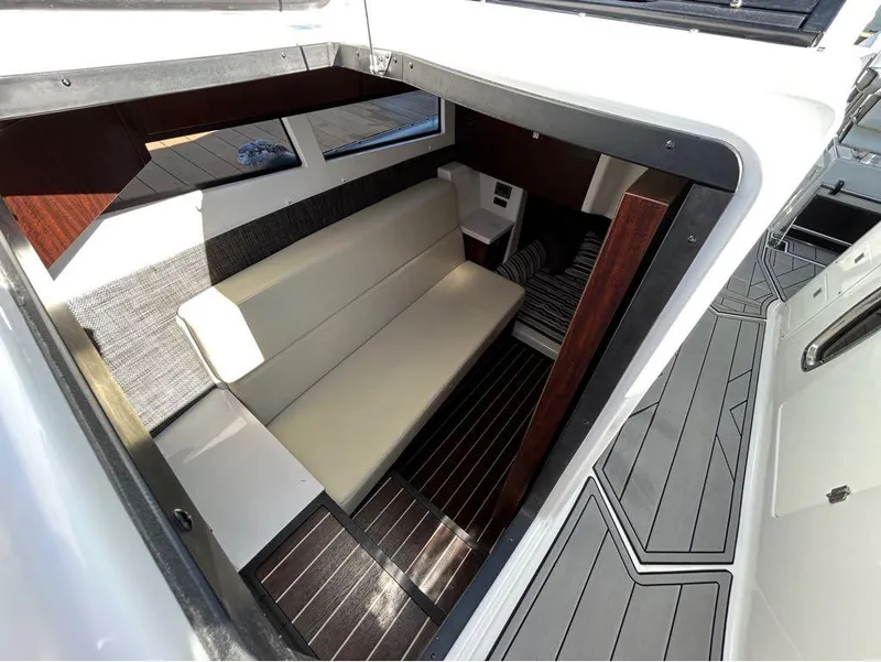 Slide: The Image of Interior cabin of 2019 Monterey 385 SE boat with beige seating and wood accents. - 20