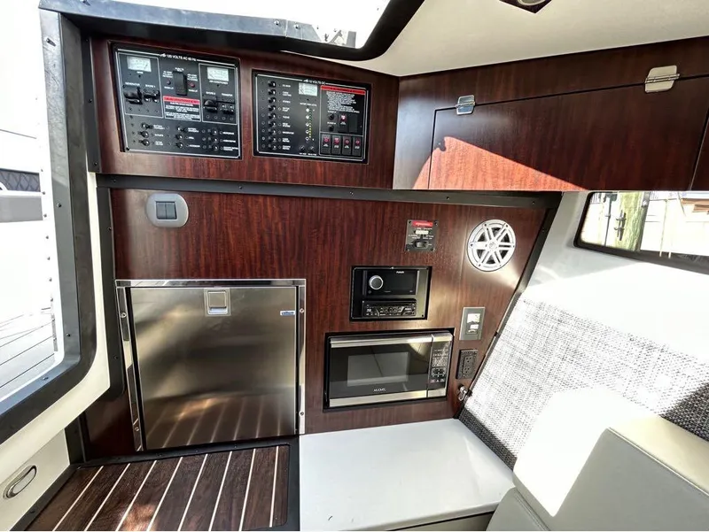 Slide: The Image of 2019 Monterey 385 SE interior control panel, microwave, and refrigerator. - 21