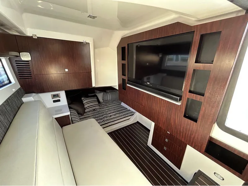 Slide: The Image of Luxurious interior of 2019 Monterey 385 SE yacht with TV, bed, and seating area. - 22
